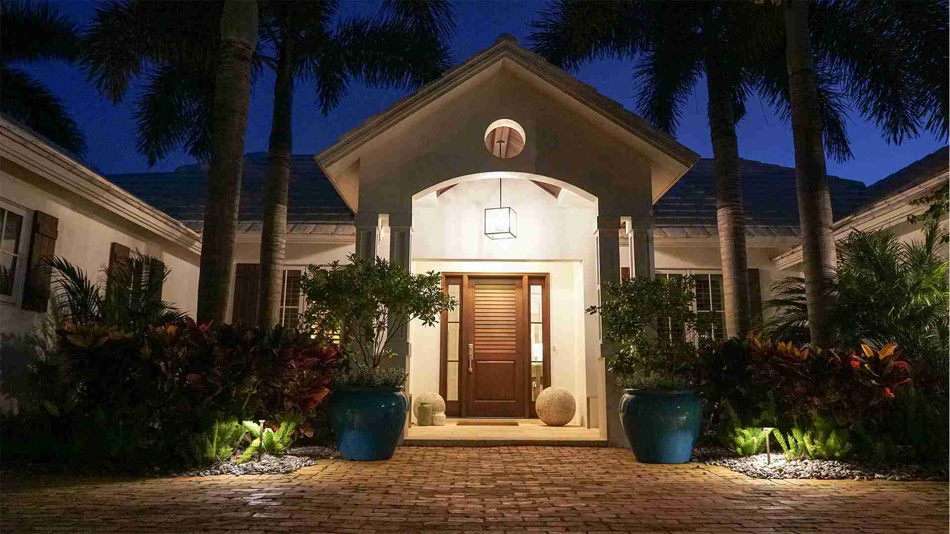 Beautiful entrance at night Entrance landscaping in Naples by Executive Lawn Care