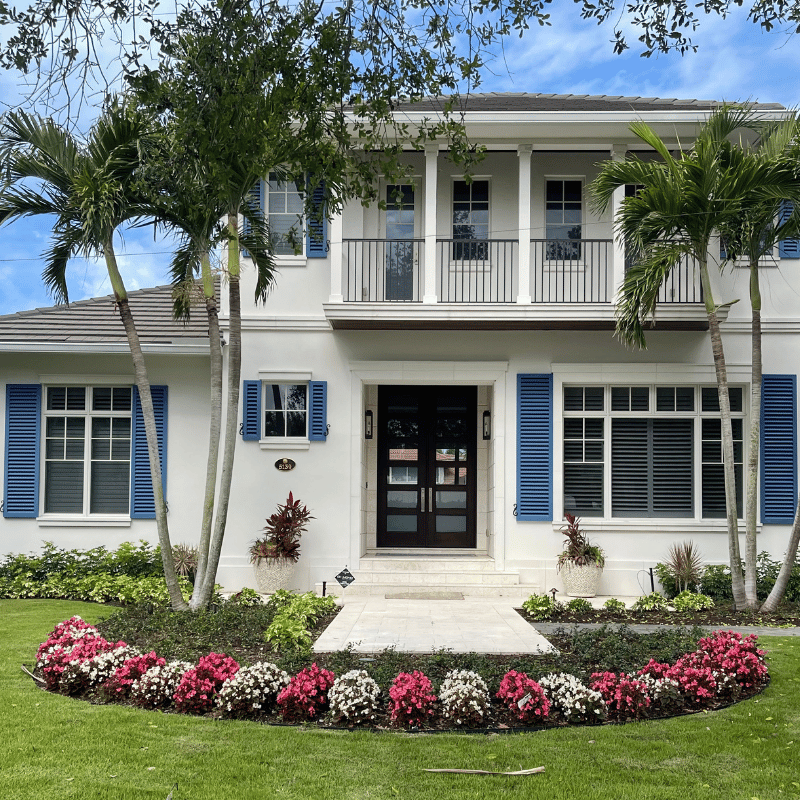 Pretty flowers framing a home entrance Flower planting in Naples by Executive Lawn Care