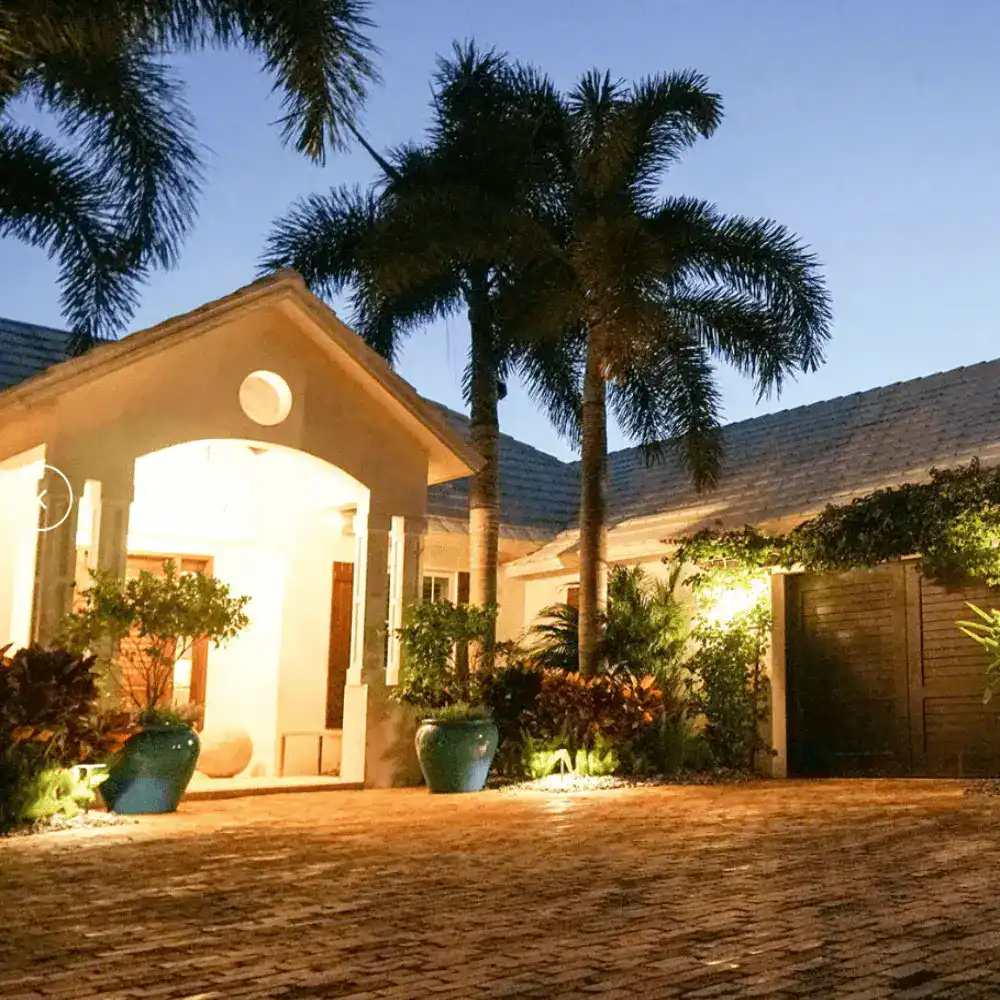 Entrance accent lighting in Naples by Executive Lawn Care at dusk